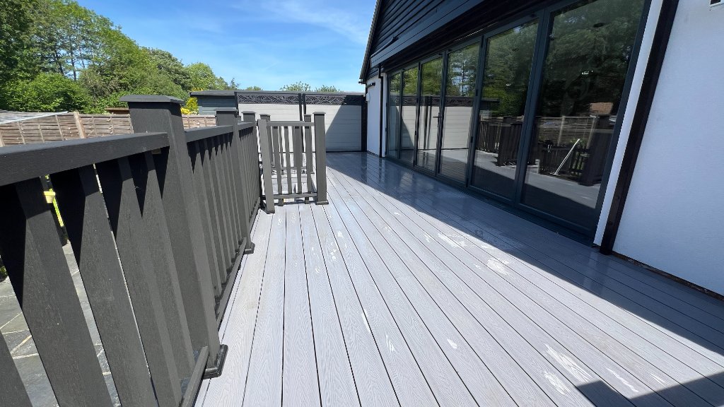 Grey composite deck with bi-fold doors Godalming Surrey
