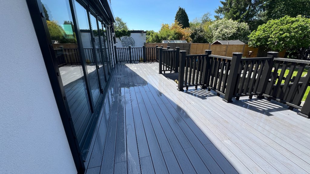 Composite deck alongside bifold doors Godalming Surrey 5 Star Decking
