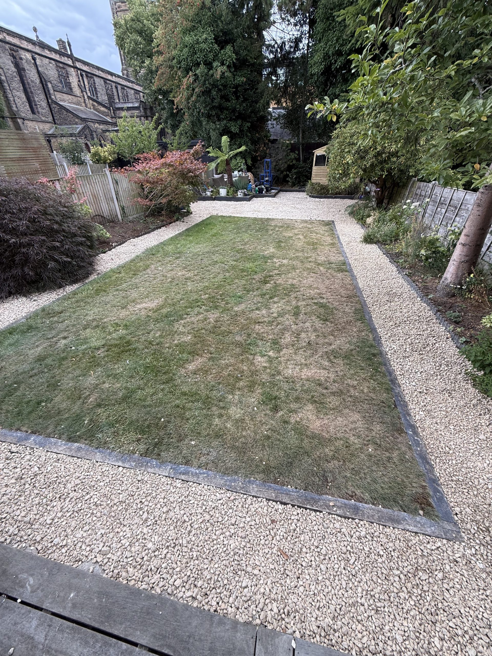 Rear garden boundary at Ashwood Avenue showing mature trees and natural screening