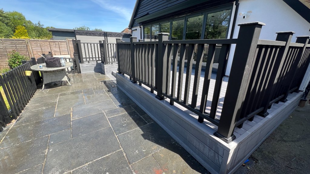 Raised composite decking installation in South Manchester with black aluminium balustrade